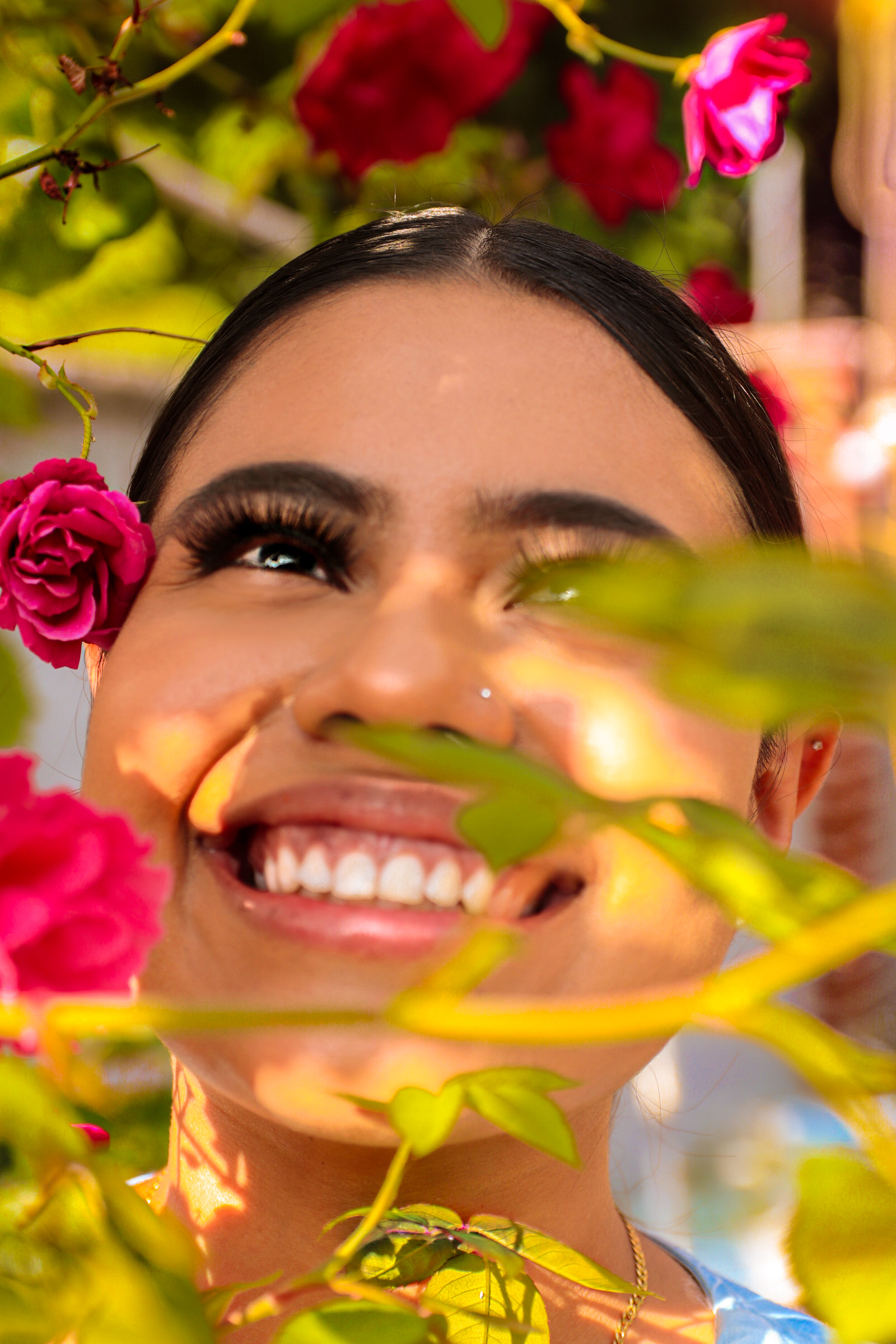 Close up portrait of woman smiling through flowers