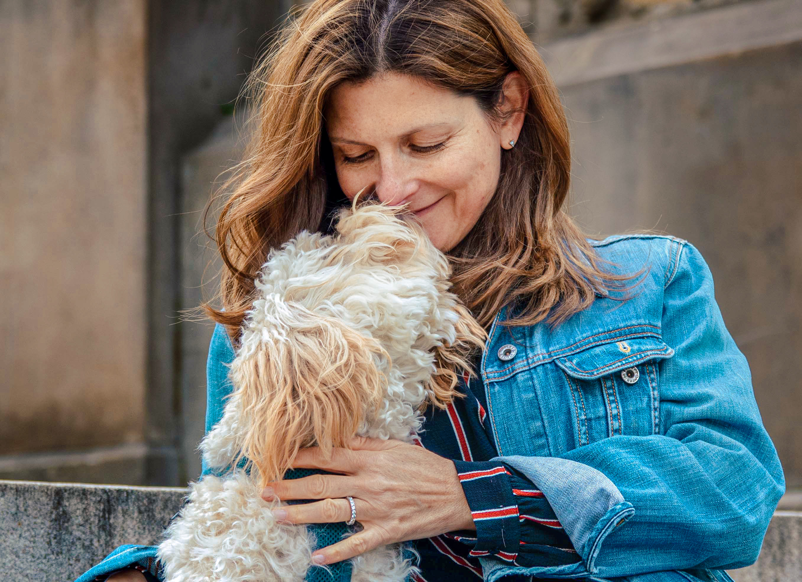 Photo of dog owner getting licked by her dog